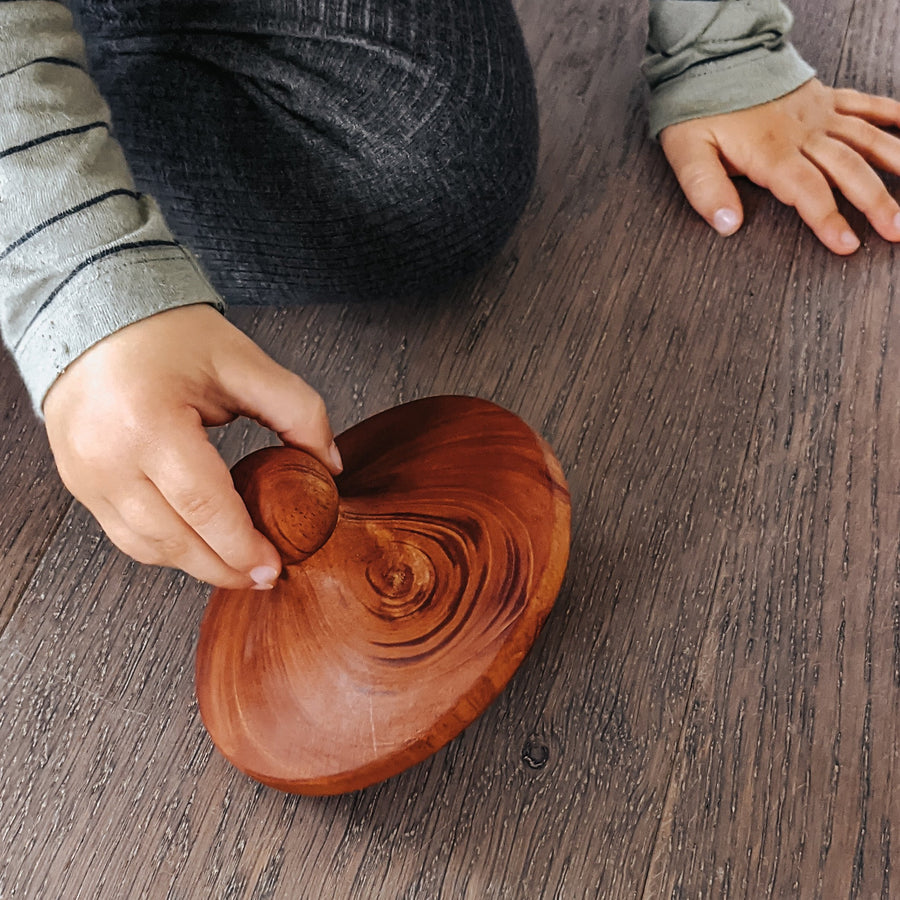 Natural wooden spinning top toy.  Hand turned from sustainably sourced wood and sealed with beeswax.