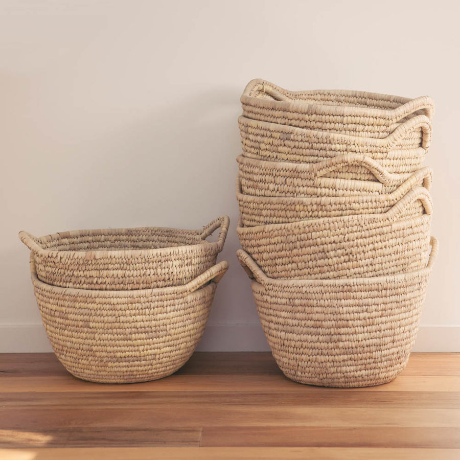Eco-friendly handwoven round basket with handles. 