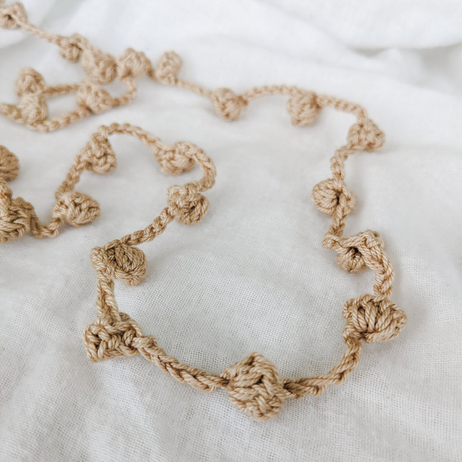 A beautiful hand crocheted garland made from 100% cotton. Perfect for children's  bedrooms or as  a sustainable decor option for special occasions like baby showers and birthdays. 