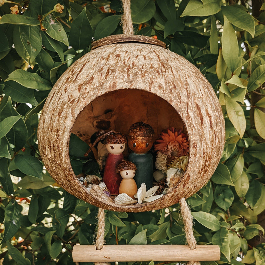 Fair trade hanging fairy house ethically made from coconut shell and plantation timber. 