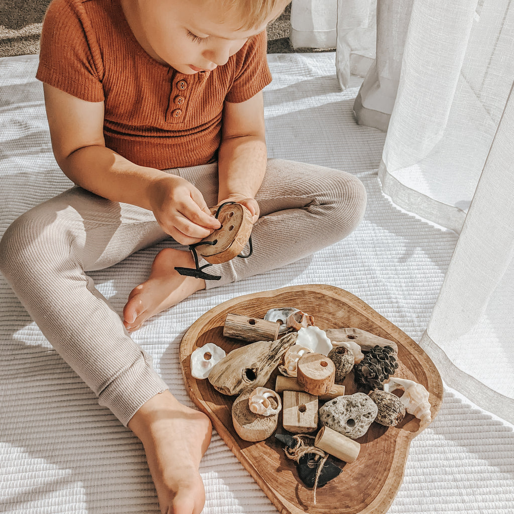 Educational wooden toy threading set.