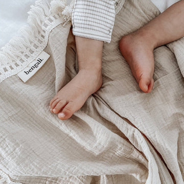 Cotton Muslin Fringe Swaddle in Oatmeal. Ethically-made, eco-friendly children's accessories NZ. 