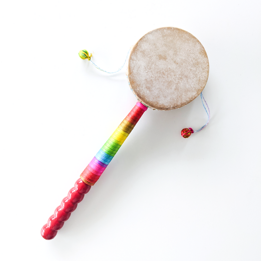 kids hand drum with a brightly rainbow-coloured handle